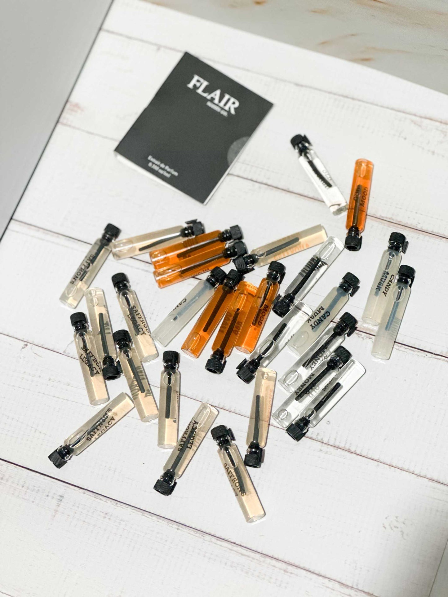 Perfume Sample Set™ displaying 8 1ml vials with luxurious fragrances for sampling before purchasing a full bottle.
