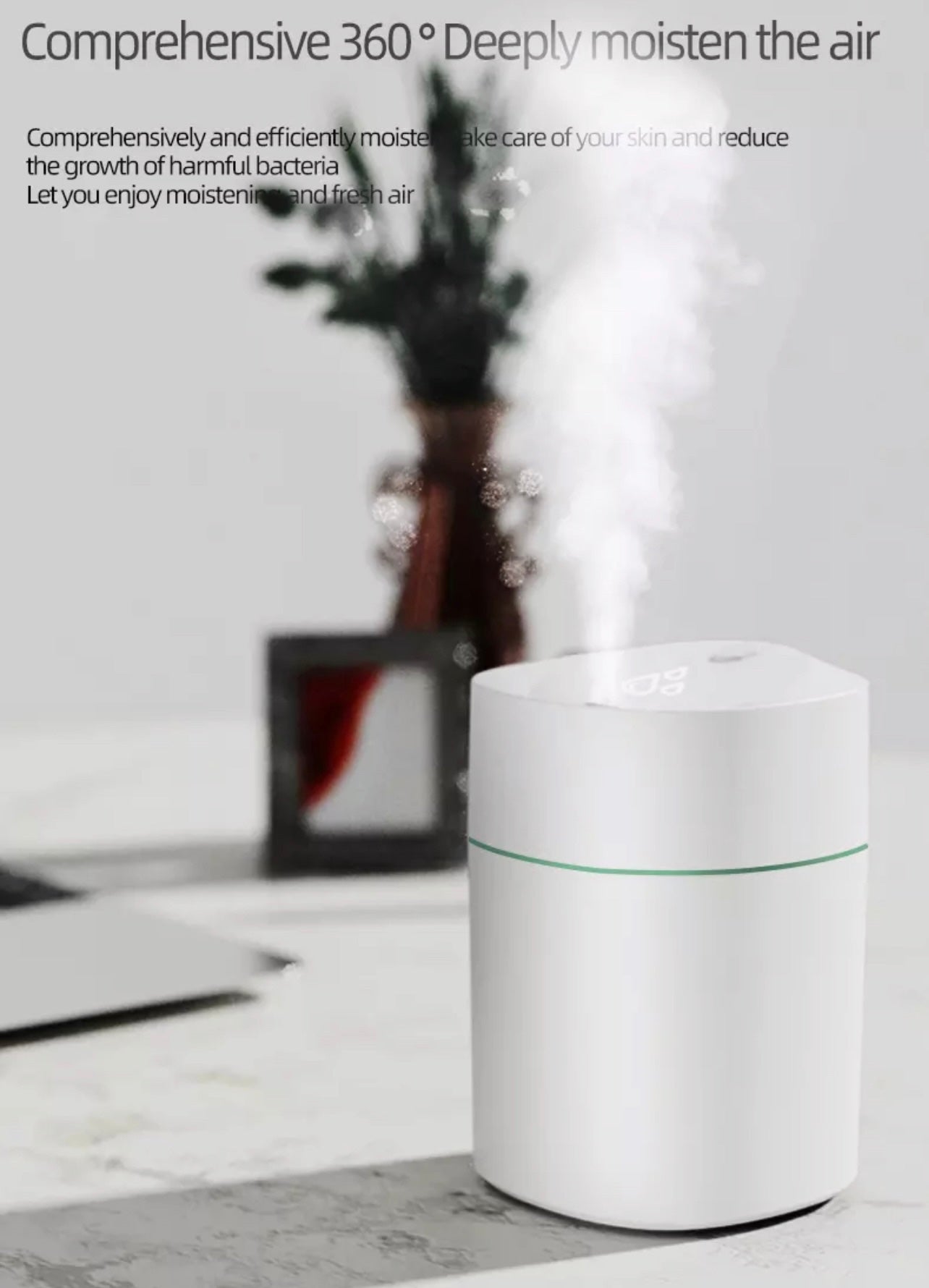 Mini ultrasonic scent buster humidifier emitting mist on table, compact and portable design for home and office use