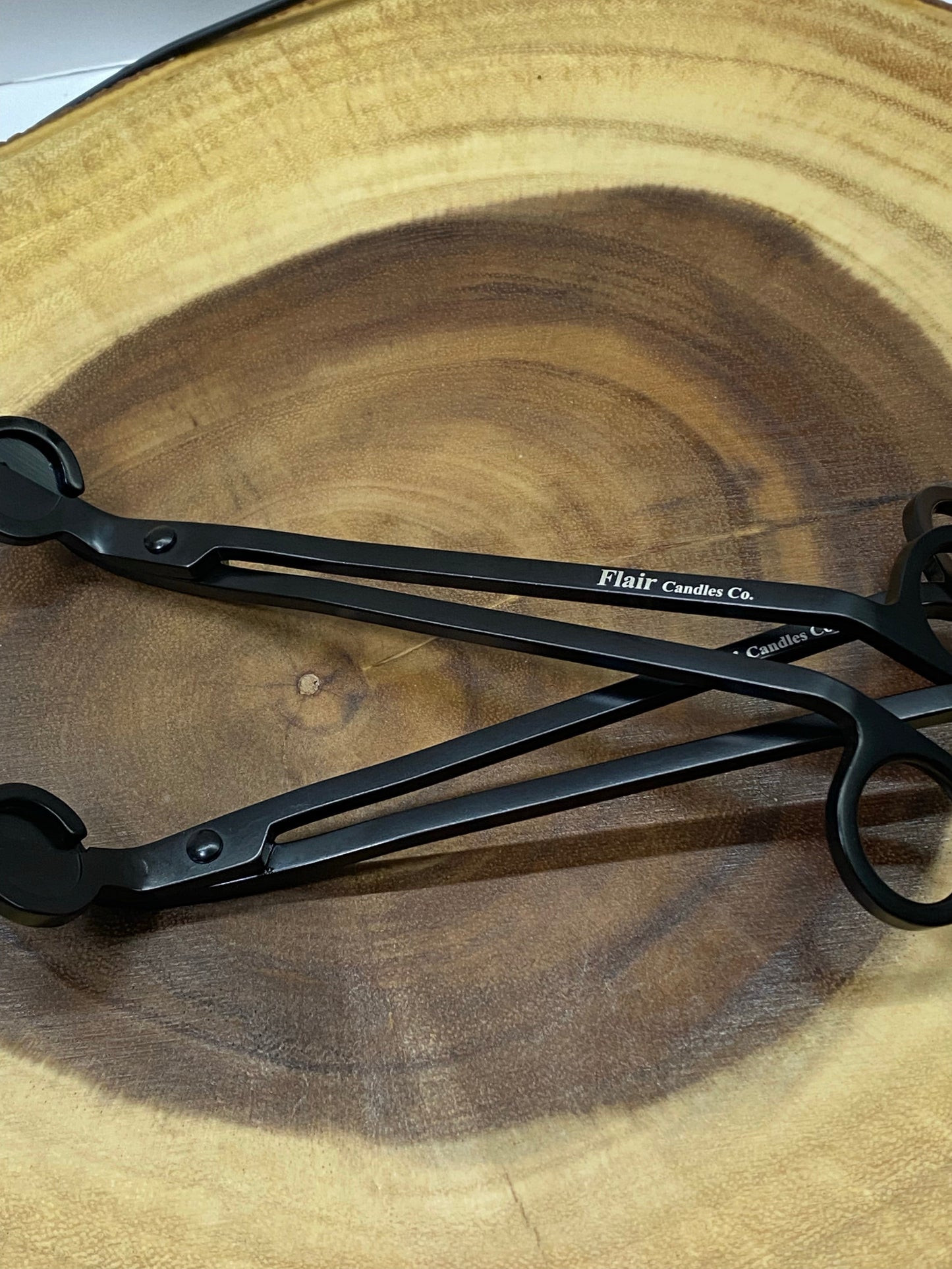 Candle wick trimmer tool used to trim wicks for brighter, cleaner candle flames