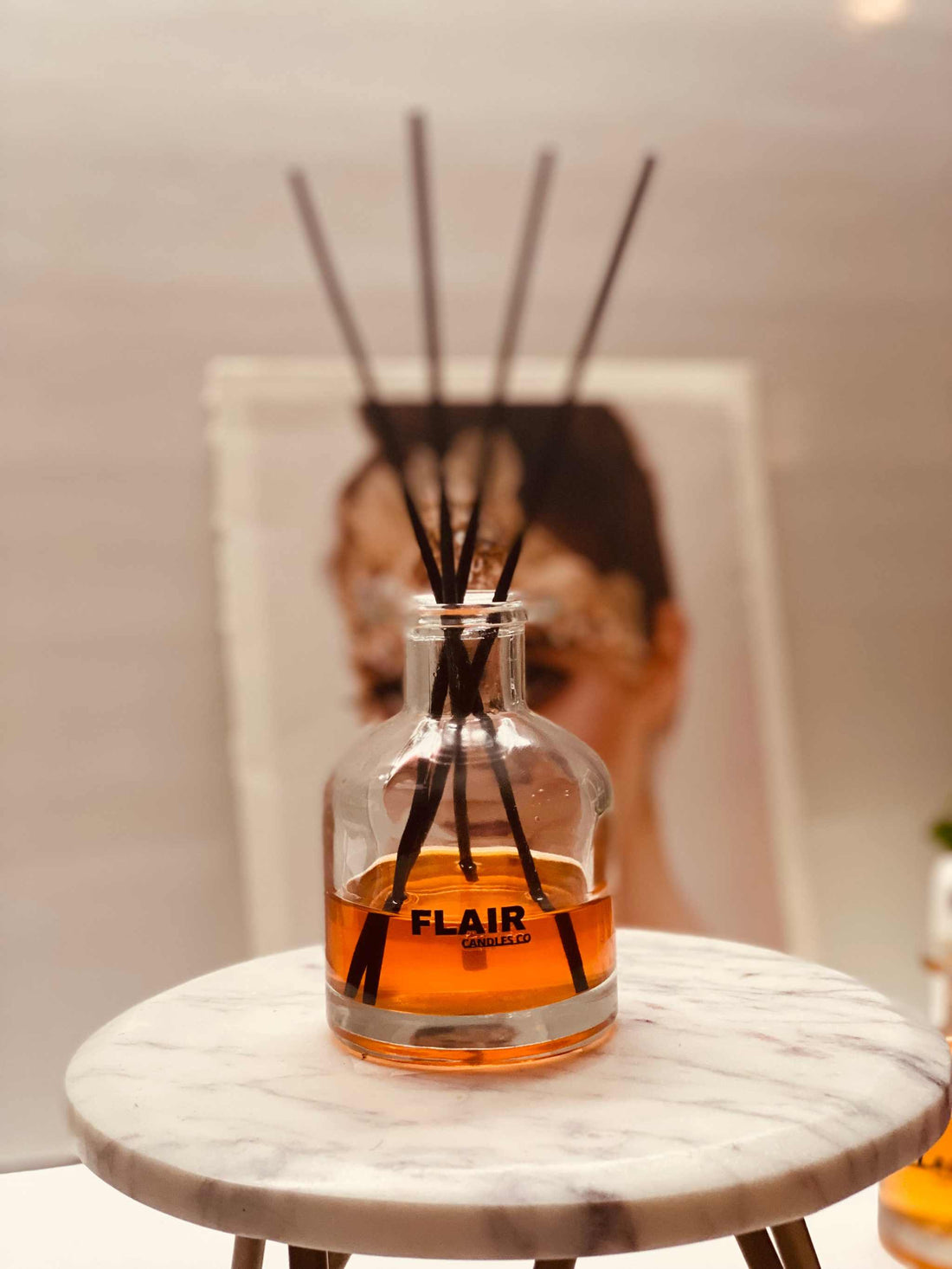 Flair Scents Co. Lush reed diffuser next to a candle