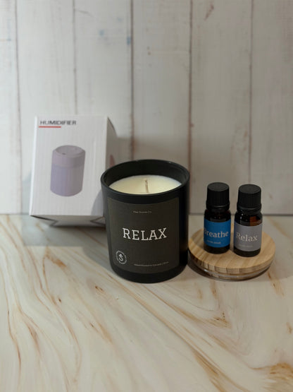 Reset Ritual at-home self-care bundle featuring a calming candle, mini humidifier, and essential oils arranged in a peaceful, minimalist setting.