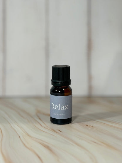 bottle of Relax essential oil blend with eucalyptus spearmint on wooden surface