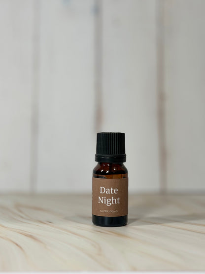 Date Night essential oil blend bottle with sweet raspberry scent on wooden surface