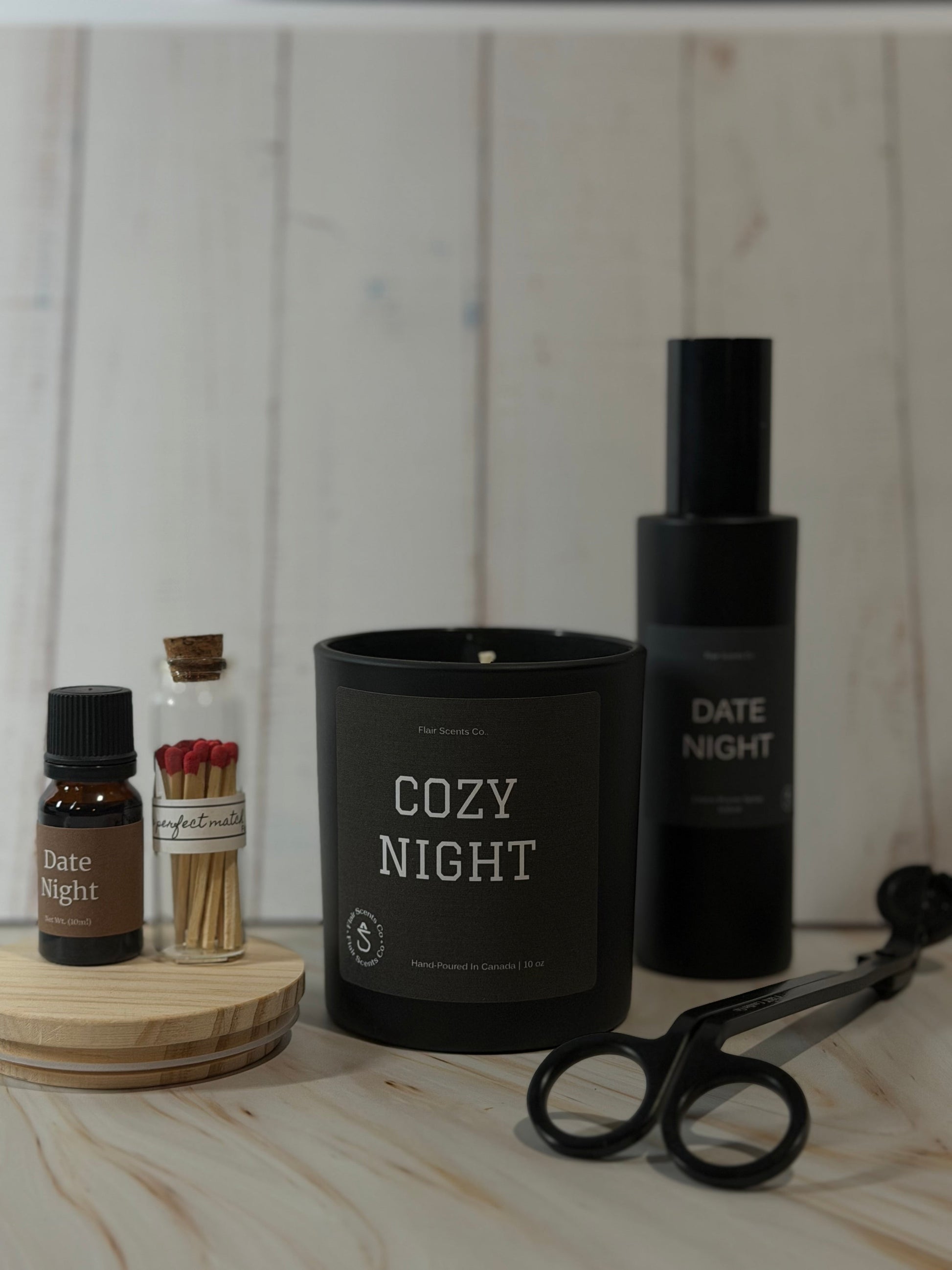 Evening Reset Bundle night routine self-care set featuring a calming candle, room spray, essential oil, wick trimmer, and match sticks arranged in a peaceful home setting.