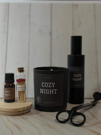 Evening Reset Bundle night routine self-care set featuring a calming candle, room spray, essential oil, wick trimmer, and match sticks arranged in a peaceful home setting.