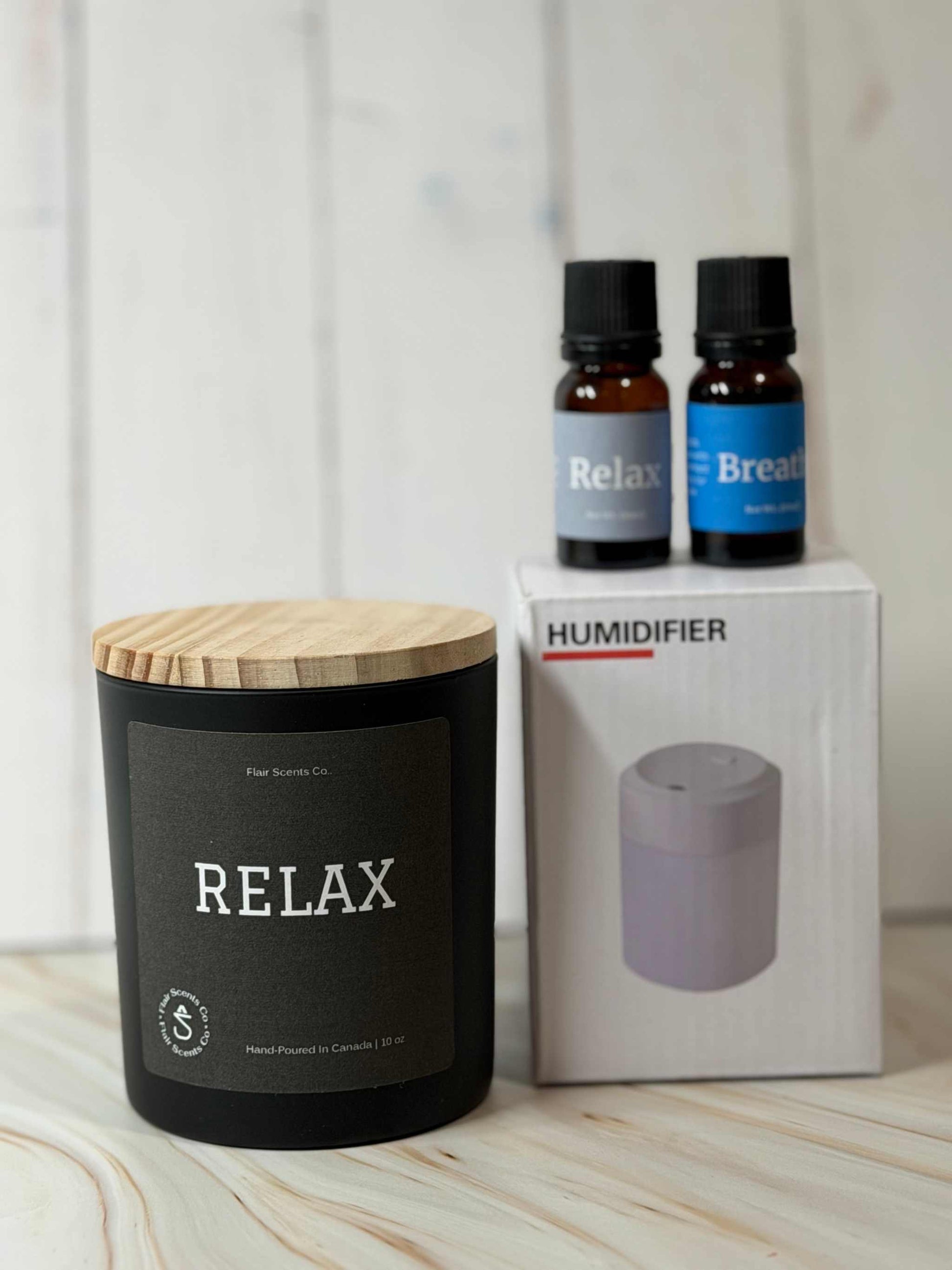 Reset Ritual at-home self-care bundle featuring a calming candle, mini humidifier, and essential oils arranged in a peaceful, minimalist setting.
