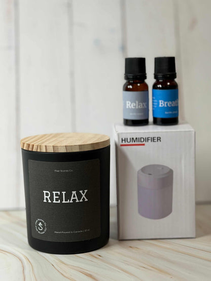 Reset Ritual at-home self-care bundle featuring a calming candle, mini humidifier, and essential oils arranged in a peaceful, minimalist setting.