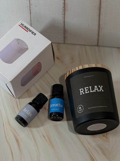 Reset Ritual at-home self-care bundle featuring a calming candle, mini humidifier, and essential oils arranged in a peaceful, minimalist setting.