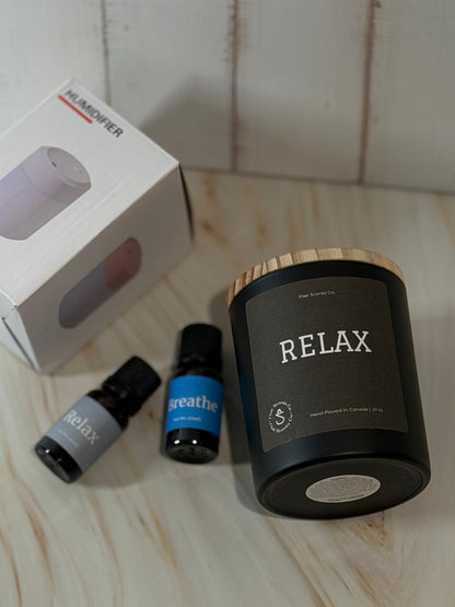 Reset Ritual at-home self-care bundle featuring a calming candle, mini humidifier, and essential oils arranged in a peaceful, minimalist setting.