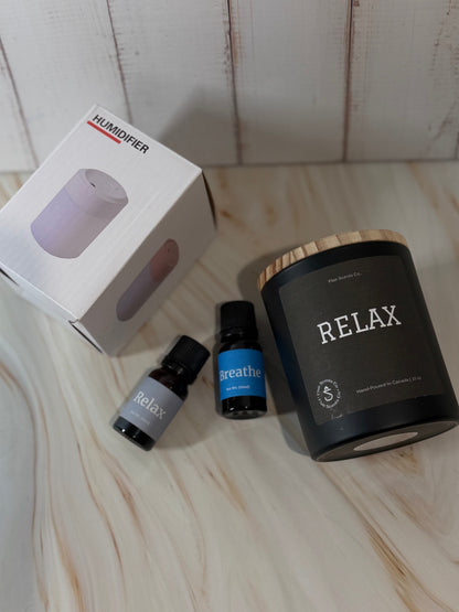 Reset Ritual at-home self-care bundle featuring a calming candle, mini humidifier, and essential oils arranged in a peaceful, minimalist setting.