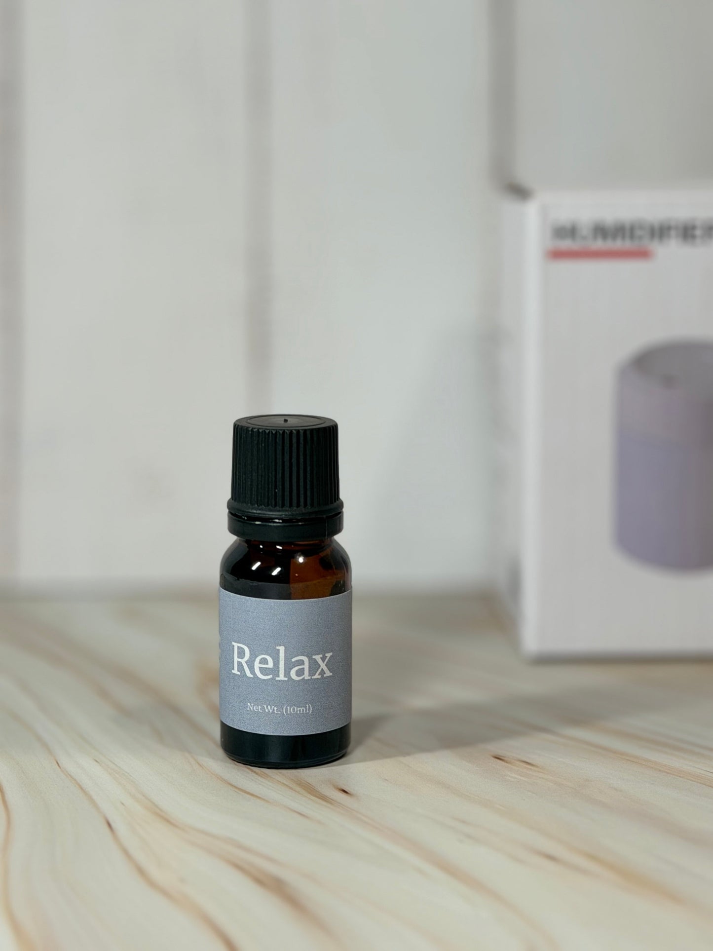 Relax essential oil blend bottle with eucalyptus spearmint scent on wooden surface