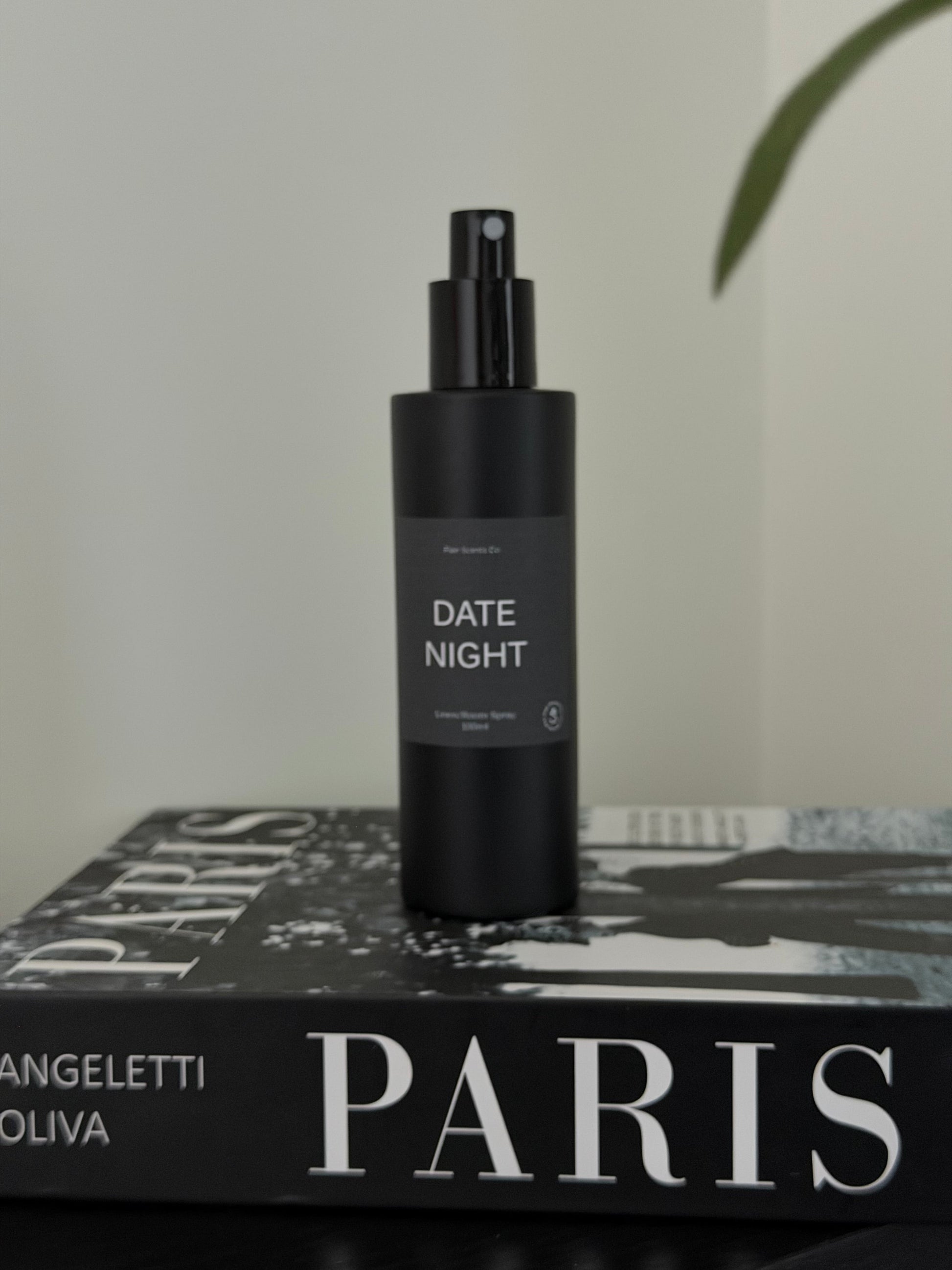 Bottle of Date Night room spray with enchanting scent of jasmine, raspberry, and rose petals