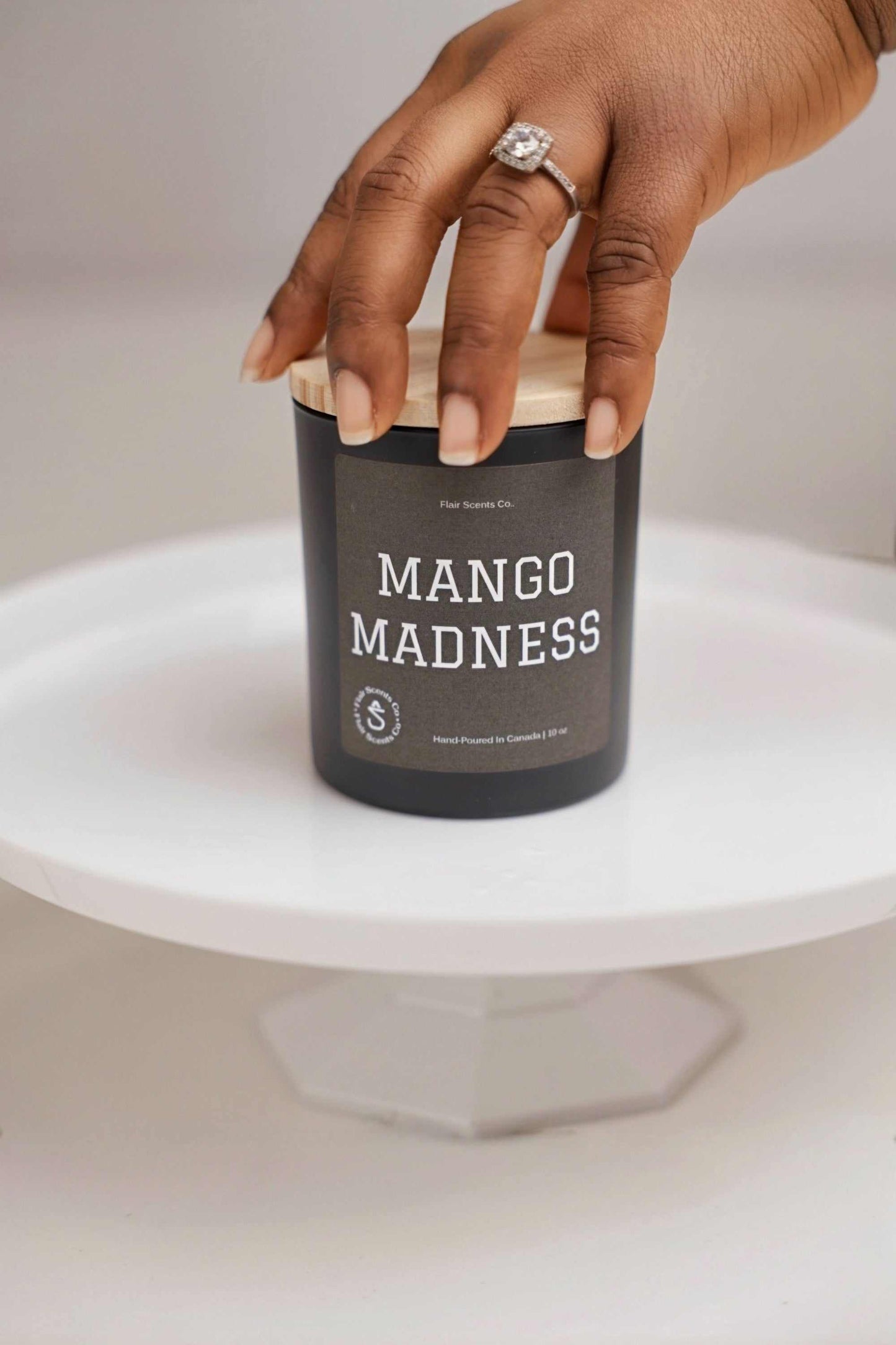 Mango Madness™ candle with tropical mango, pineapple, and vanilla scent in a glass jar.